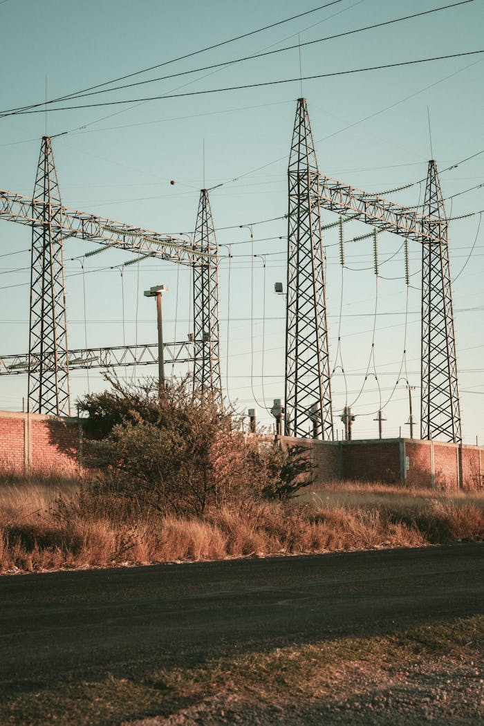 Home Rustic open field showcasing a high voltage electrical substation during daytime.