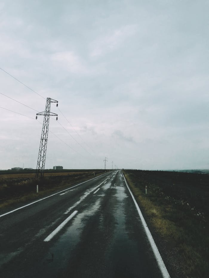An empty rural road with power lines on a rainy day in Taşköprü, Kırklareli, Turkey.